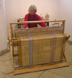 Fiona weaving a blanket on her floor loom